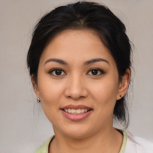 Joyful asian young-adult female with medium  brown hair and brown eyes