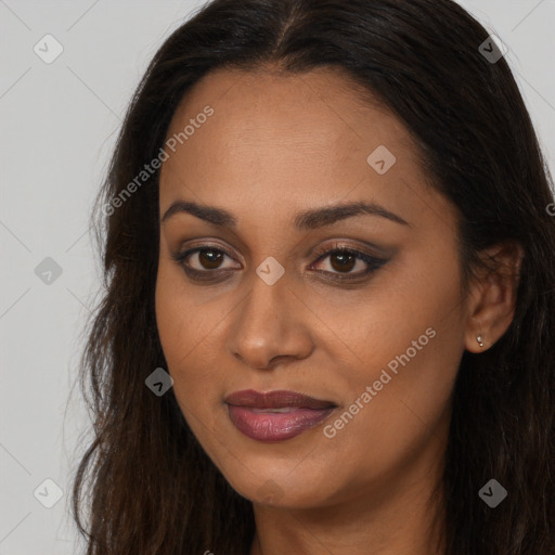 Joyful black young-adult female with long  brown hair and brown eyes