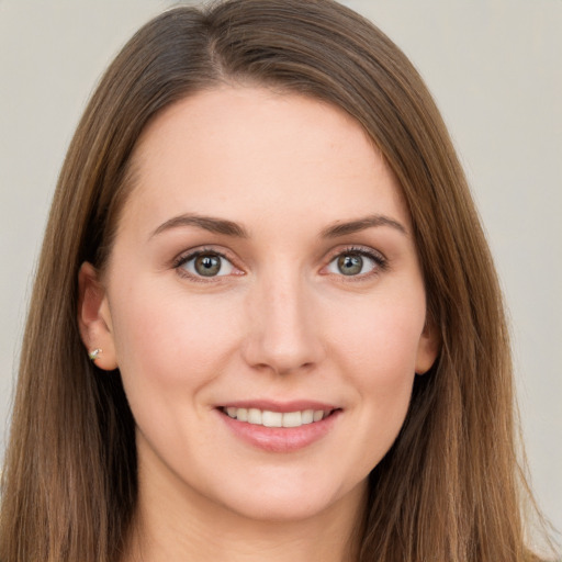 Joyful white young-adult female with long  brown hair and grey eyes