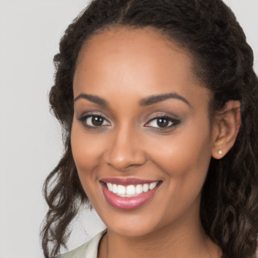 Joyful latino young-adult female with long  brown hair and brown eyes