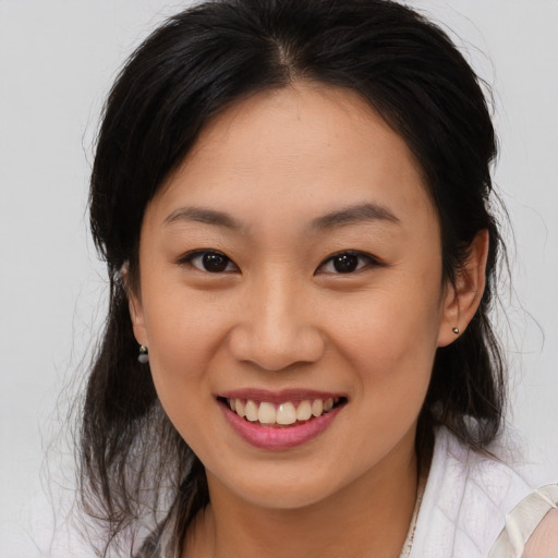 Joyful asian young-adult female with medium  brown hair and brown eyes