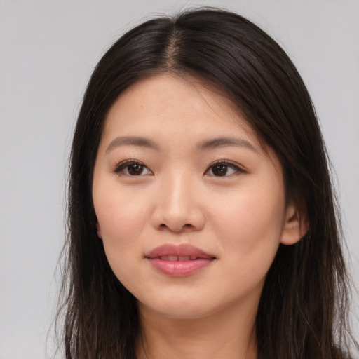Joyful asian young-adult female with long  brown hair and brown eyes