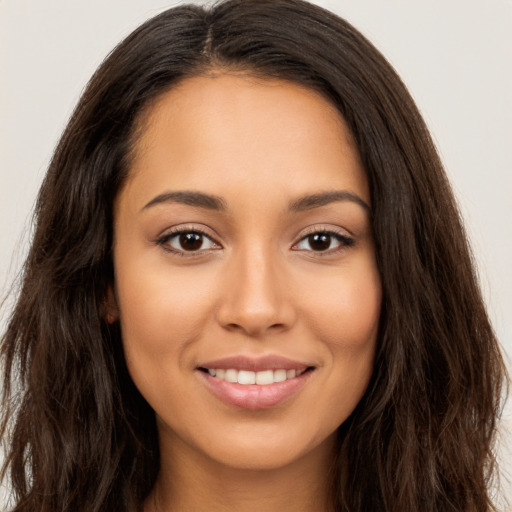 Joyful white young-adult female with long  brown hair and brown eyes