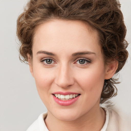 Joyful white young-adult female with medium  brown hair and green eyes