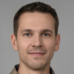 Joyful white young-adult male with short  brown hair and brown eyes