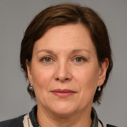 Joyful white adult female with medium  brown hair and grey eyes