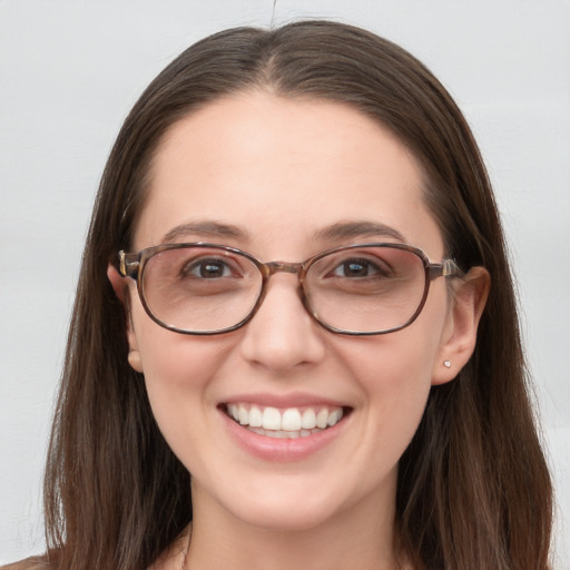 Joyful white young-adult female with long  brown hair and blue eyes