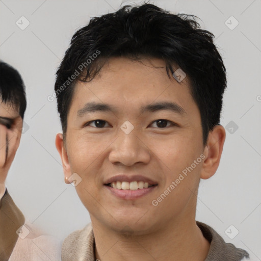 Joyful asian young-adult male with short  black hair and brown eyes