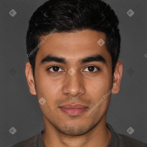 Joyful latino young-adult male with short  brown hair and brown eyes