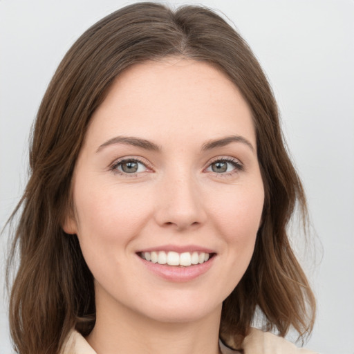 Joyful white young-adult female with medium  brown hair and green eyes