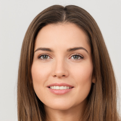 Joyful white young-adult female with long  brown hair and brown eyes