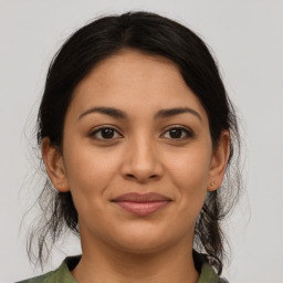 Joyful latino young-adult female with medium  brown hair and brown eyes