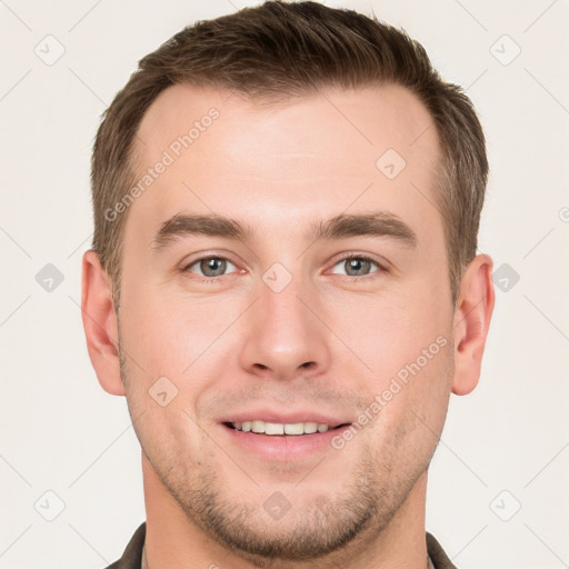 Joyful white young-adult male with short  brown hair and grey eyes