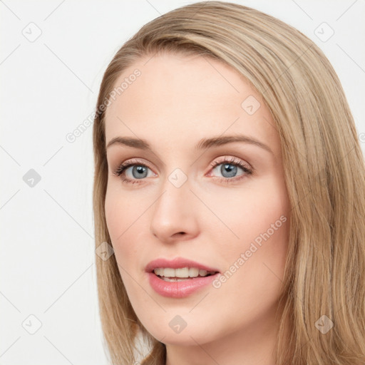 Joyful white young-adult female with long  brown hair and blue eyes