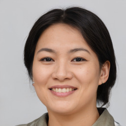 Joyful asian young-adult female with medium  brown hair and brown eyes