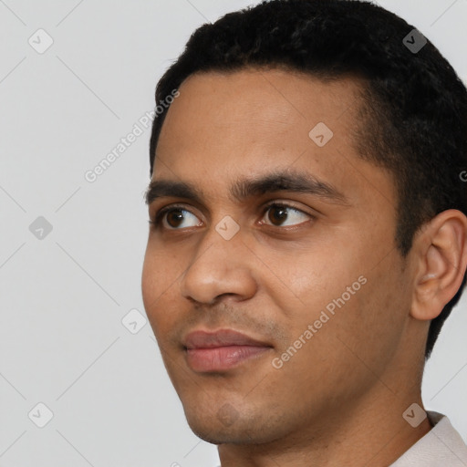 Joyful latino young-adult male with short  black hair and brown eyes