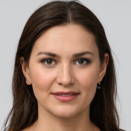 Joyful white young-adult female with long  brown hair and grey eyes