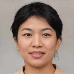 Joyful asian young-adult female with medium  brown hair and brown eyes