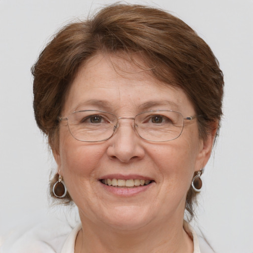 Joyful white middle-aged female with medium  brown hair and grey eyes