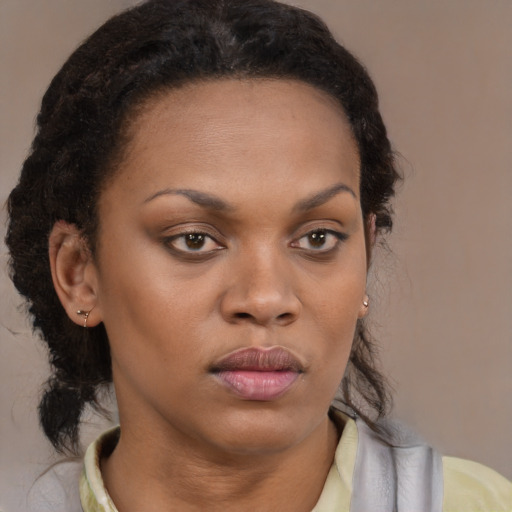 Neutral black young-adult female with medium  brown hair and brown eyes