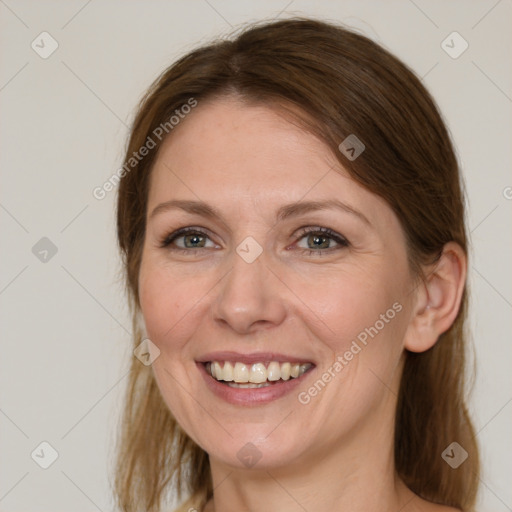 Joyful white adult female with medium  brown hair and grey eyes