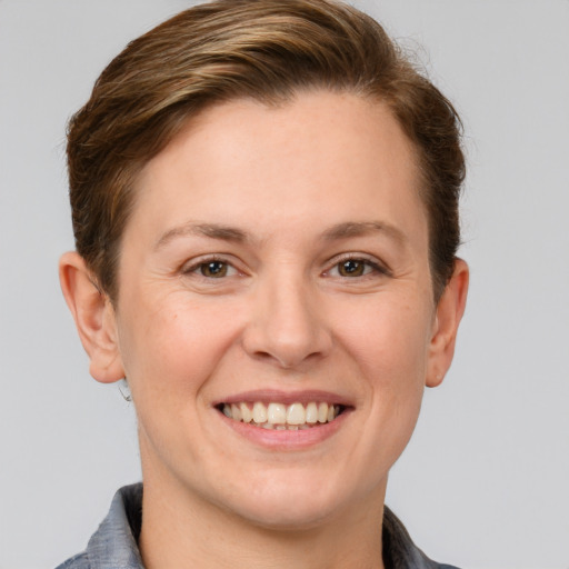 Joyful white adult female with short  brown hair and grey eyes