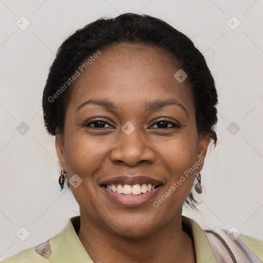 Joyful black young-adult female with short  brown hair and brown eyes