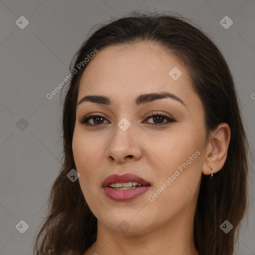 Joyful white young-adult female with long  brown hair and brown eyes