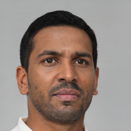 Neutral latino adult male with short  black hair and brown eyes