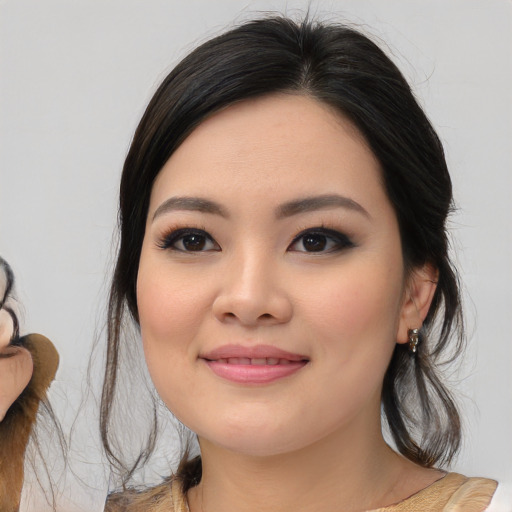 Joyful asian young-adult female with medium  black hair and brown eyes