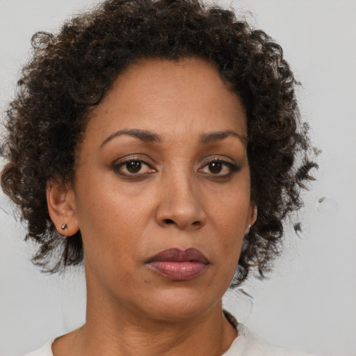 Neutral black adult female with medium  brown hair and brown eyes