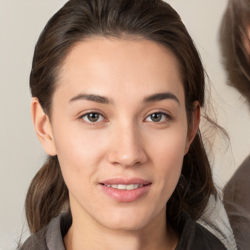 Joyful white young-adult female with medium  brown hair and brown eyes