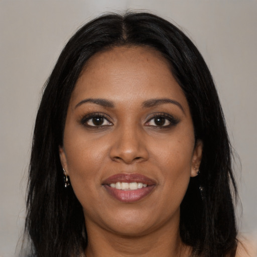 Joyful latino young-adult female with long  black hair and brown eyes
