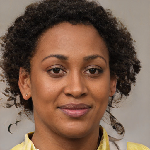 Joyful black young-adult female with medium  brown hair and brown eyes