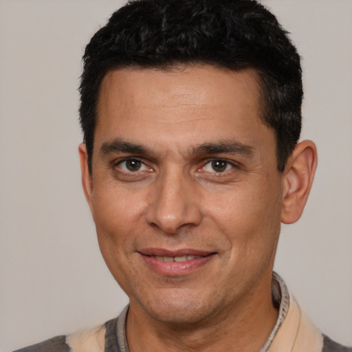 Joyful white adult male with short  brown hair and brown eyes