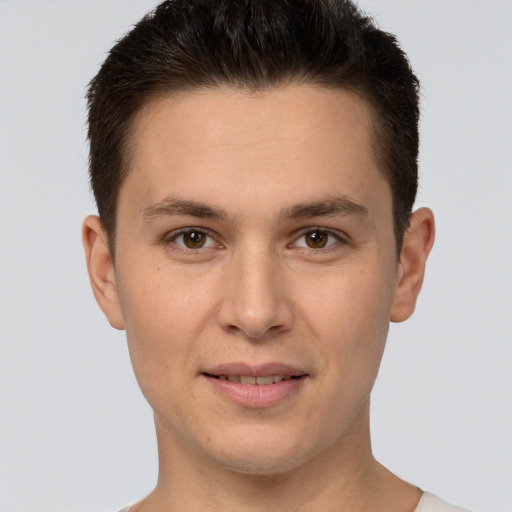 Joyful white young-adult male with short  brown hair and brown eyes