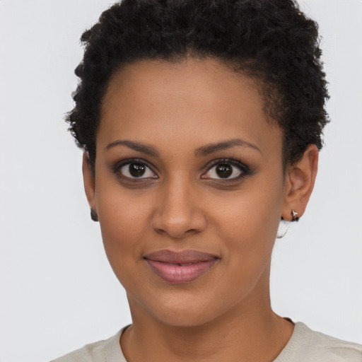 Joyful black young-adult female with short  black hair and brown eyes