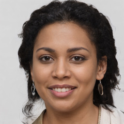 Joyful latino young-adult female with long  brown hair and brown eyes