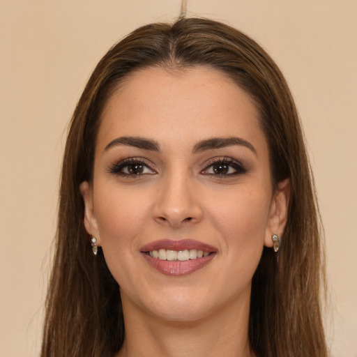 Joyful white young-adult female with long  brown hair and brown eyes