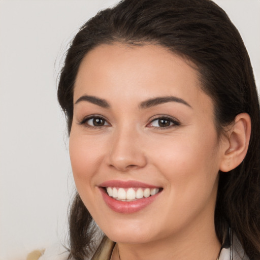 Joyful white young-adult female with long  brown hair and brown eyes