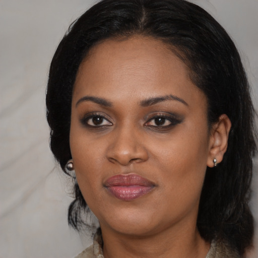 Joyful black young-adult female with medium  black hair and brown eyes