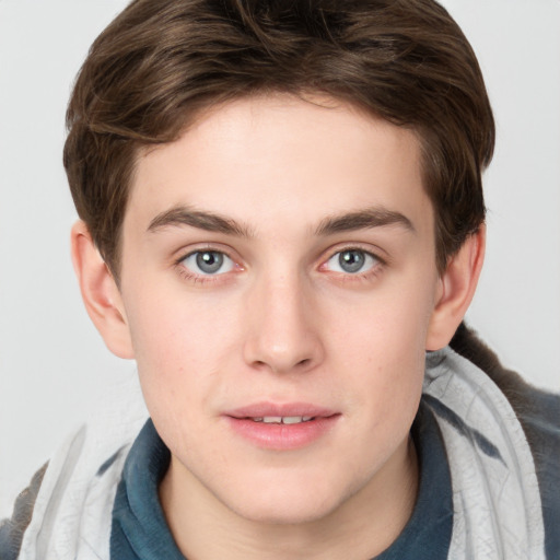 Joyful white young-adult male with medium  brown hair and grey eyes