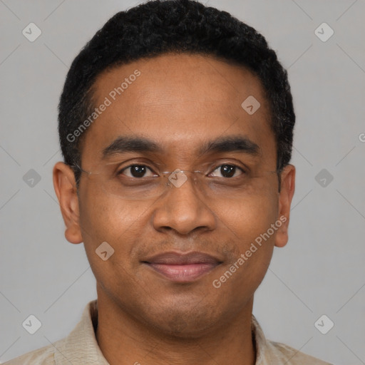 Joyful black young-adult male with short  black hair and brown eyes