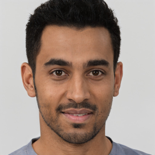 Joyful latino young-adult male with short  brown hair and brown eyes