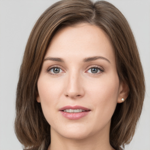 Joyful white young-adult female with medium  brown hair and green eyes