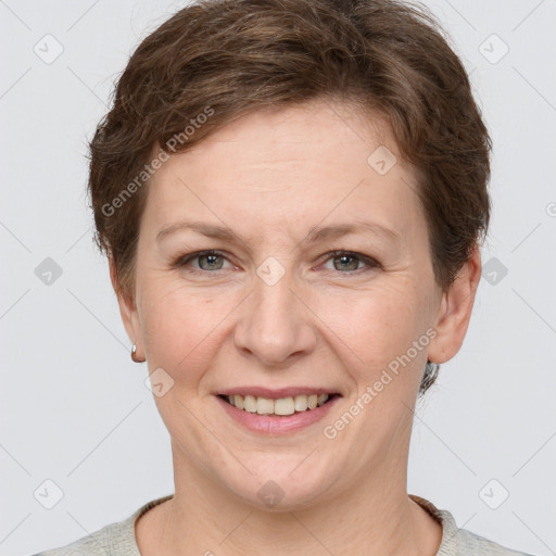 Joyful white adult female with short  brown hair and grey eyes