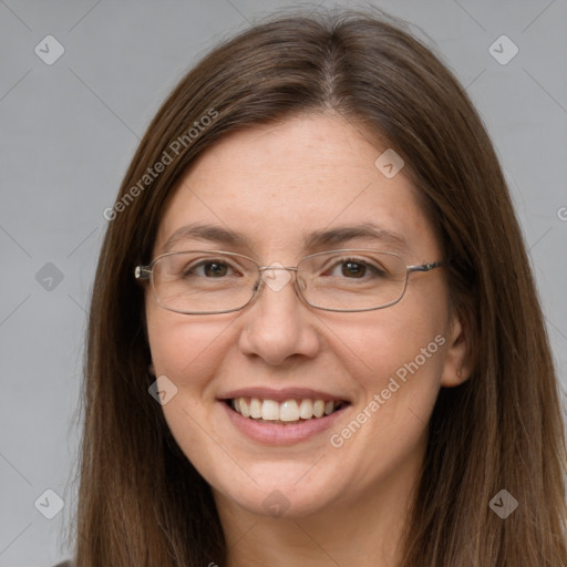 Joyful white adult female with long  brown hair and grey eyes