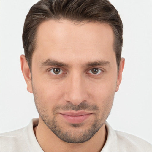 Joyful white young-adult male with short  brown hair and brown eyes