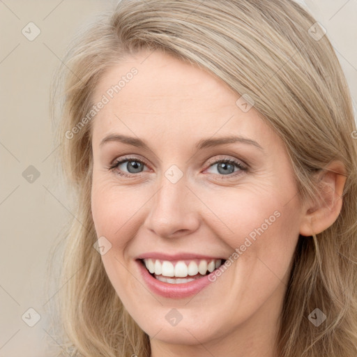 Joyful white young-adult female with long  brown hair and blue eyes