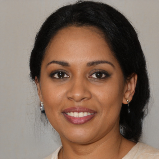 Joyful black young-adult female with medium  black hair and brown eyes